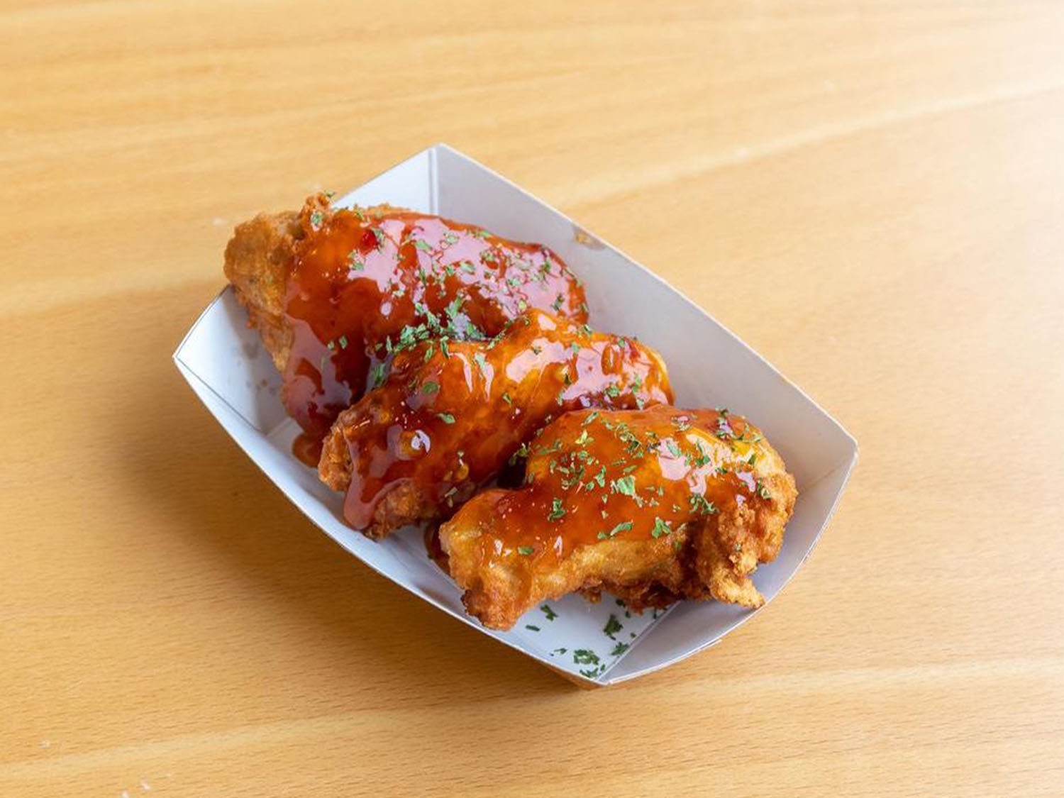 Spicy glazed chicken wings with herbs at Fusion Poke, an Asian Fusion Restaurant in Milwaukee