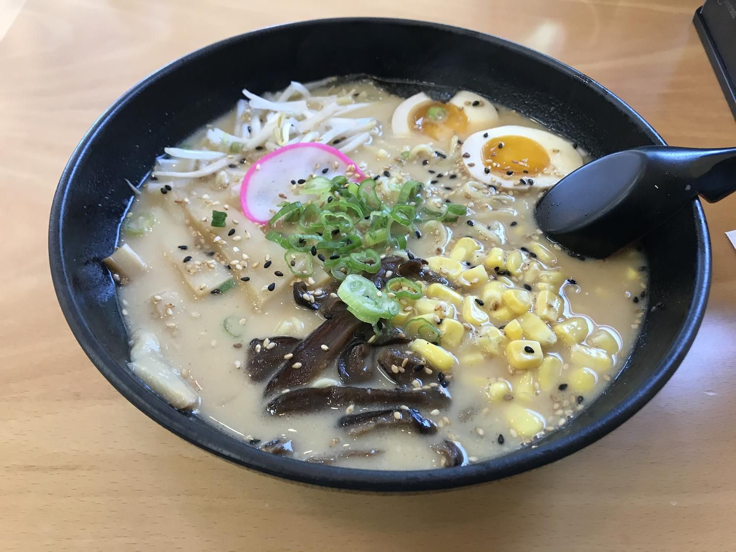 Creamy vegetarian tonkotsu ramen with mushrooms and corn at Fusion Poke, an Asian Fusion Restaurant in Milwaukee