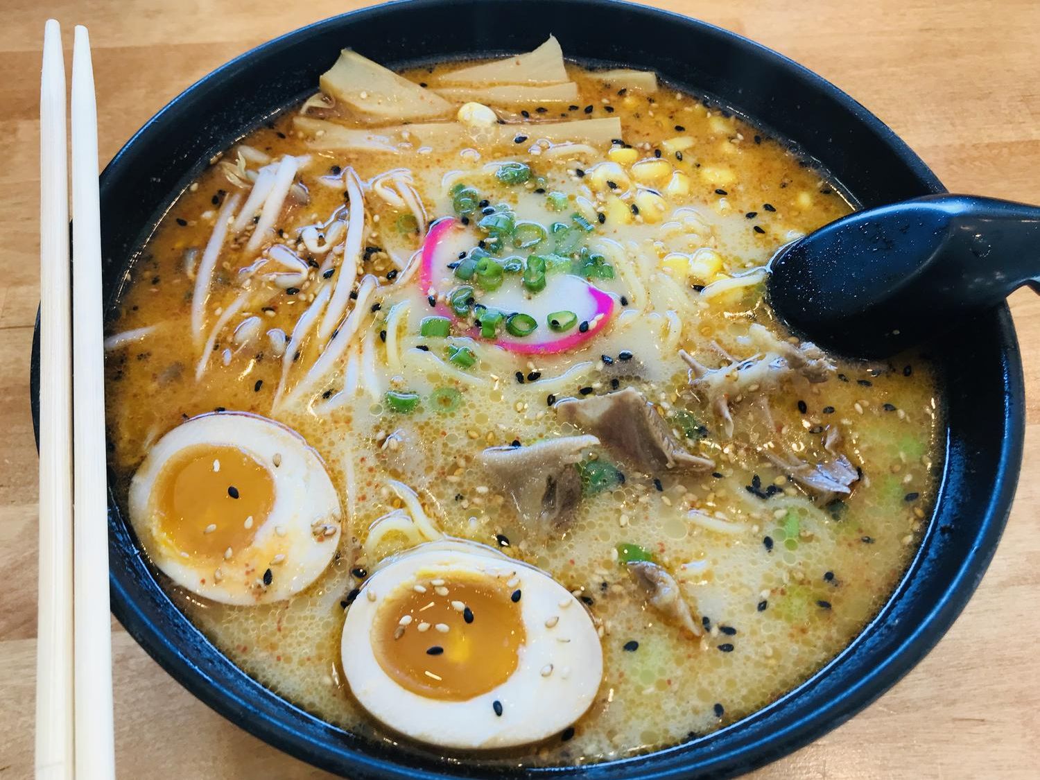 Spicy tonkotsu ramen with soft-boiled egg and corn at Fusion Poke, an Asian Fusion Restaurant in Milwaukee