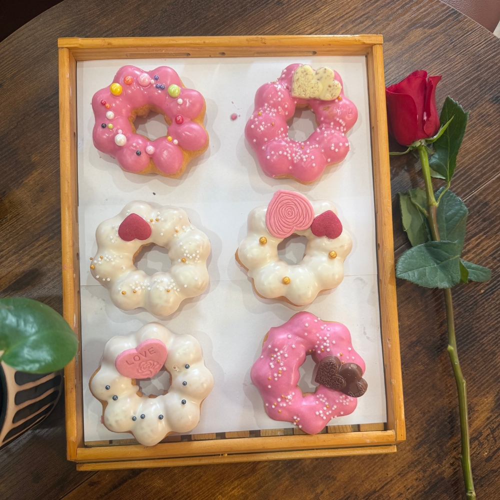Assorted pink and white mochi donuts with heart decorations at Gangnam Crispy, a Korean Restaurant in Toledo