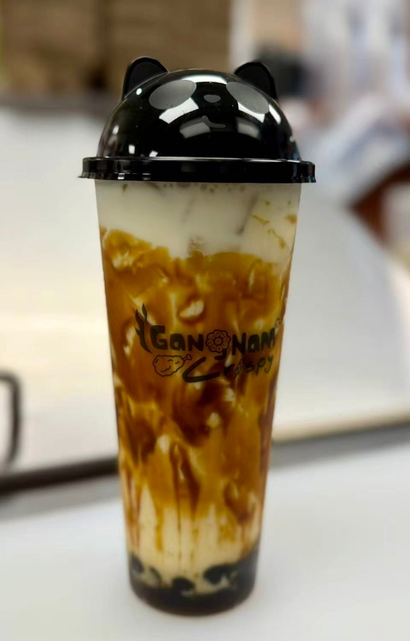 Creamy milk tea with brown sugar boba and cat ear lid at Gangnam Crispy, a Korean Restaurant in Toledo