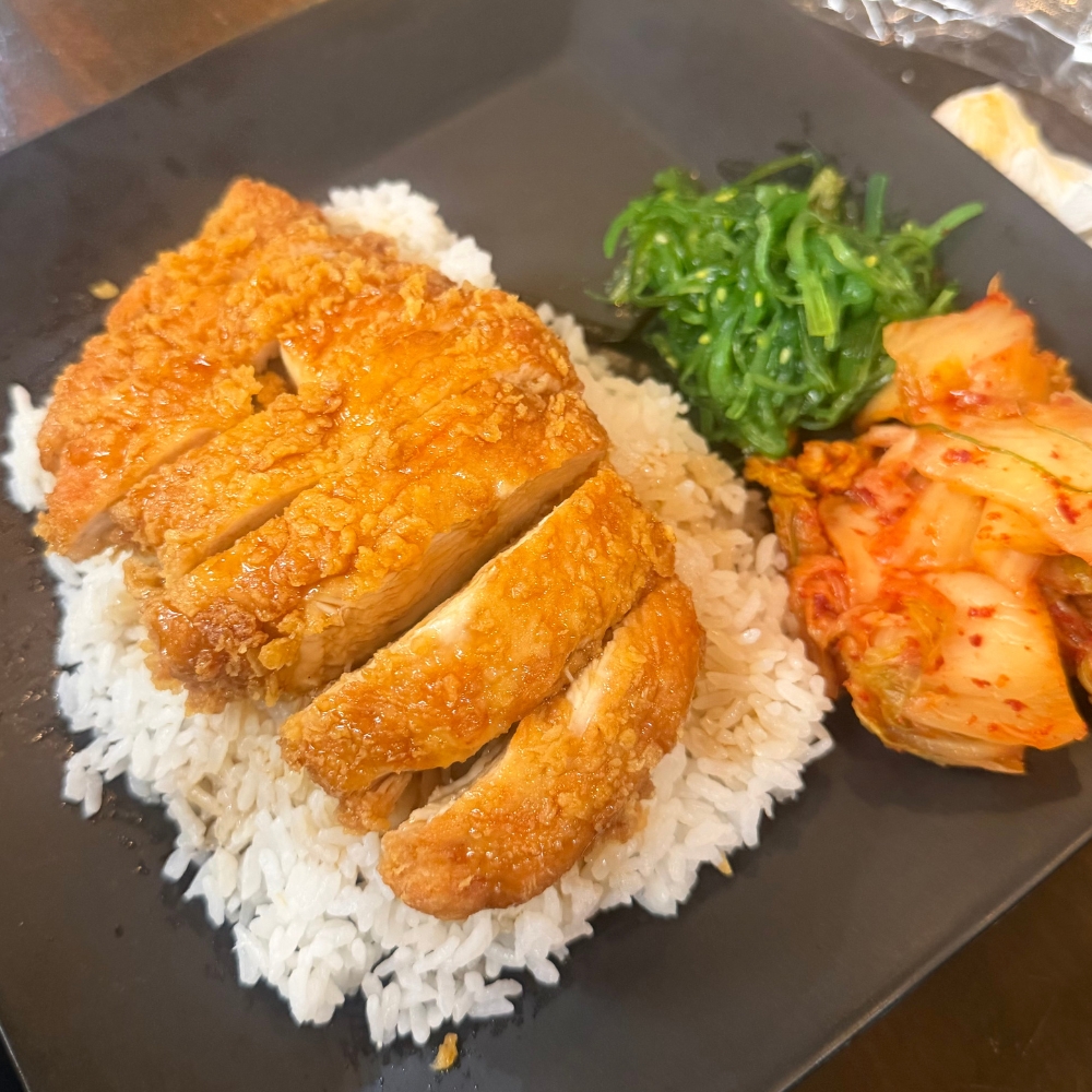 Crispy chicken cutlet over rice with kimchi and seaweed salad at Gangnam Crispy, a Korean Restaurant in Toledo