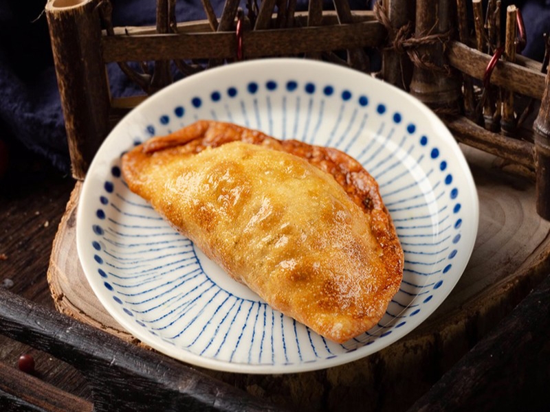 Golden crispy fried pastry with savory filling at Gao Qunsheng's Spicy Soup, a Chinese Restaurant in Flushing