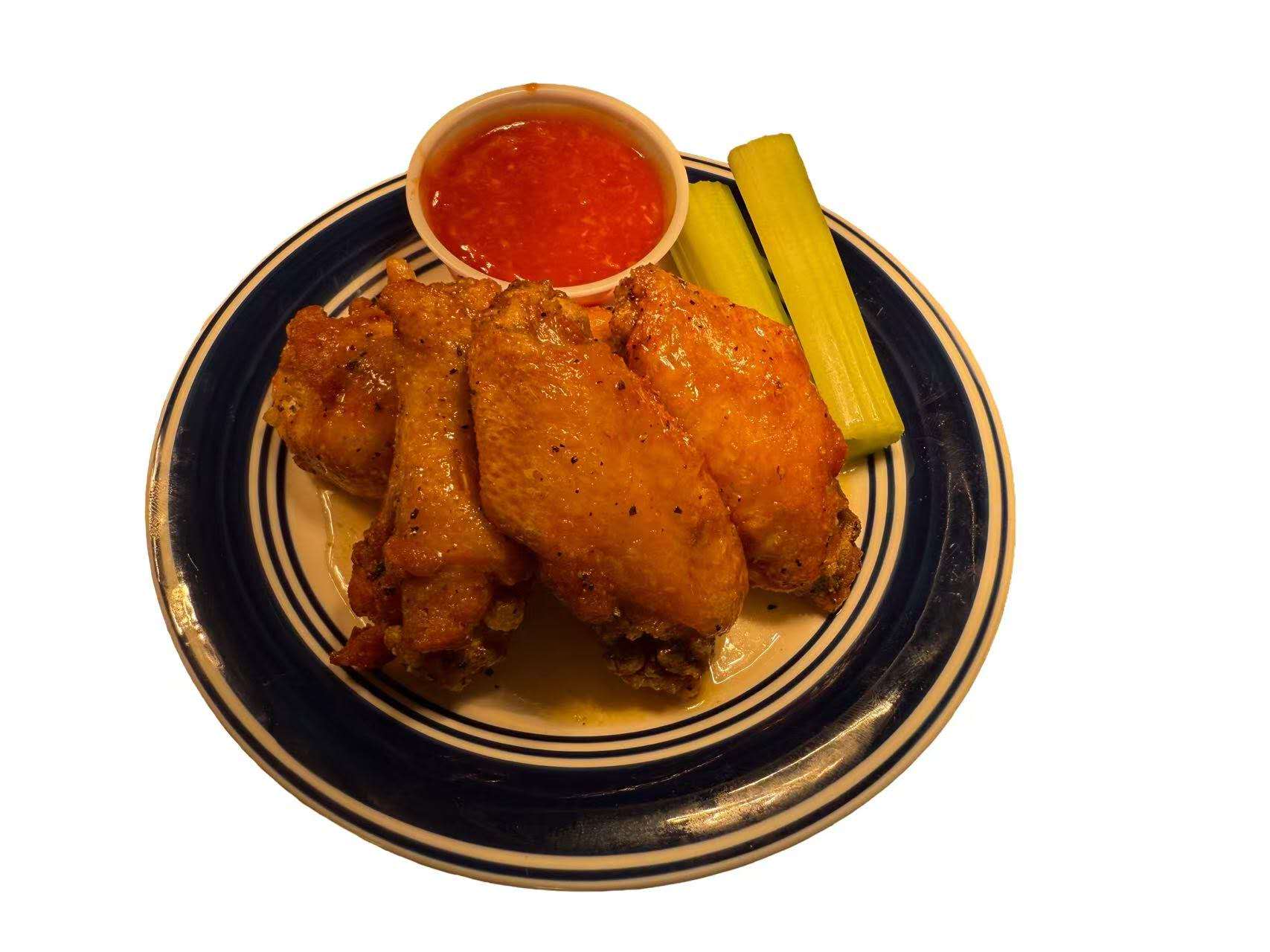 6 pieces of flavorful fried wings with dipping sauce and celery sticks at Golden Fried, a American Fast Food Restaurant in Columbia