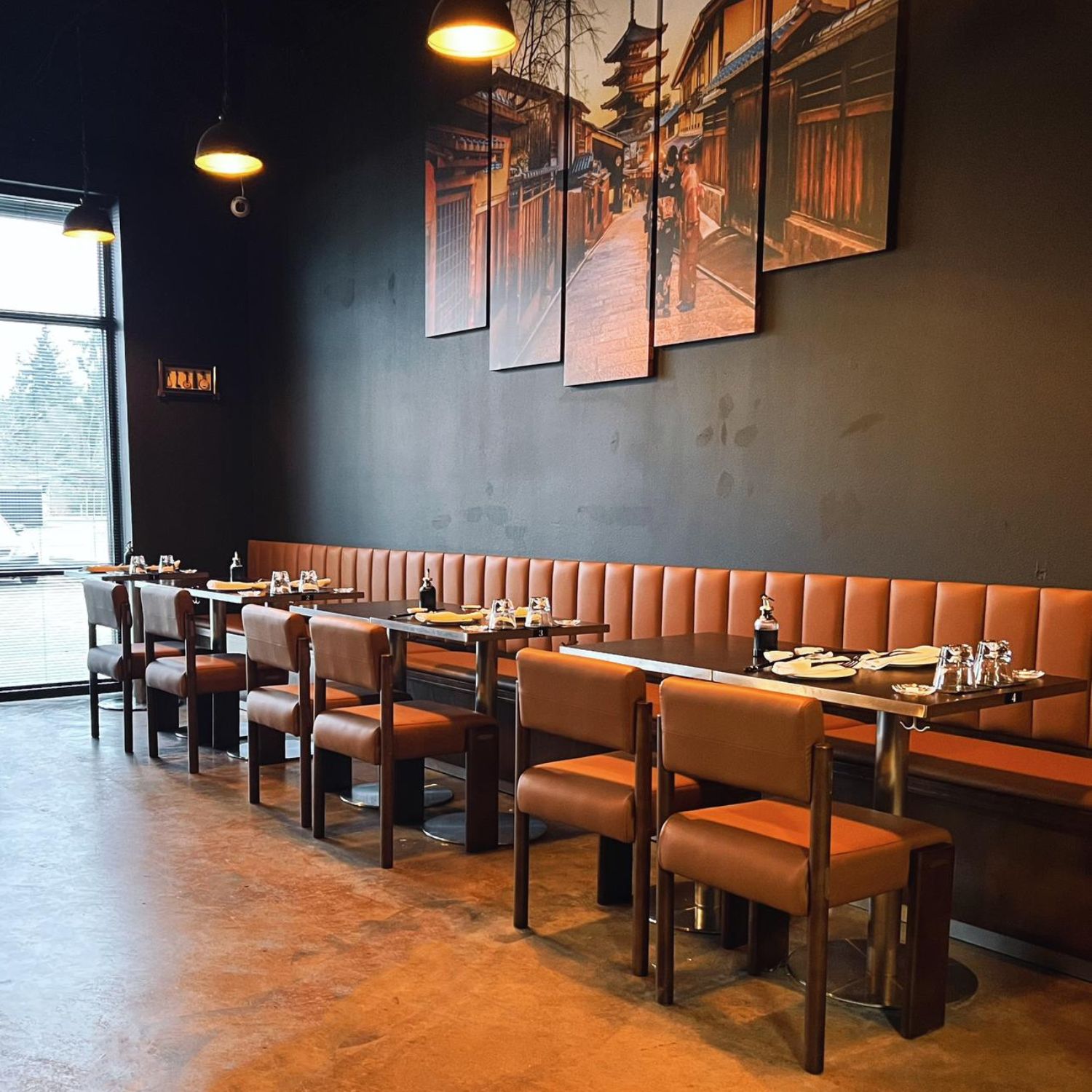 Spacious dining room with booths, chairs and Japanese-themed art at Ginza Sushi and Ramen, a Japanese Restaurant in Salem