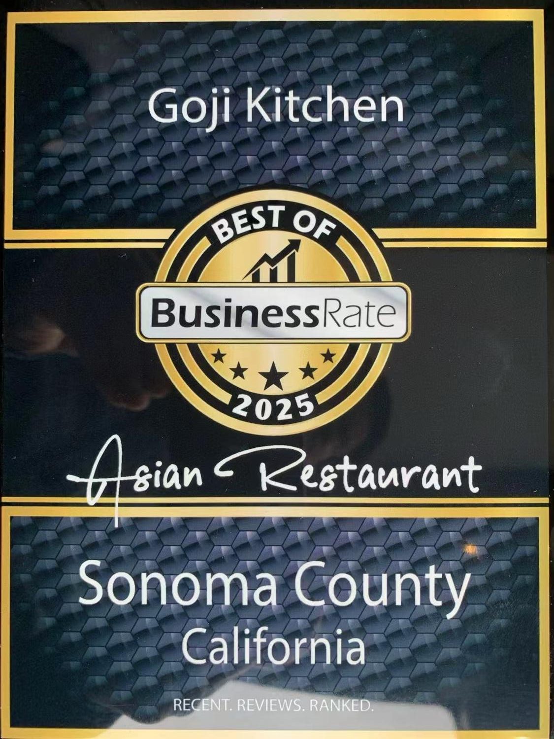 Award plaque for Goji Kitchen, named Best of BusinessRate 2025 Asian Restaurant in Sonoma County, California, with a gold and black design.