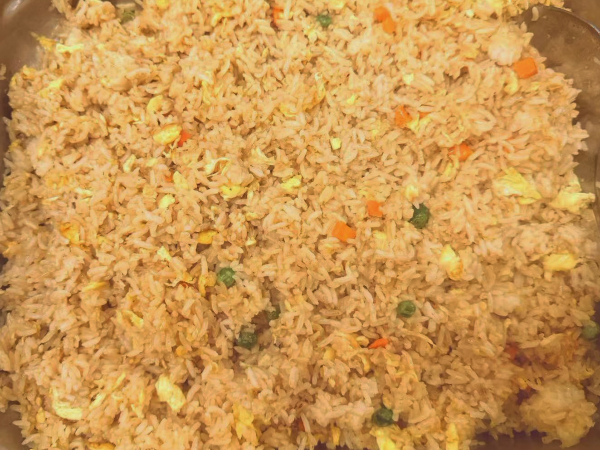 Golden-Dragon-Asian-Fusion-Restaurant-Fried-Rice-Newman A large portion of fried rice with eggs, carrots, and peas at Golden Dragon,a Asian Fusion Restaurant in Newman