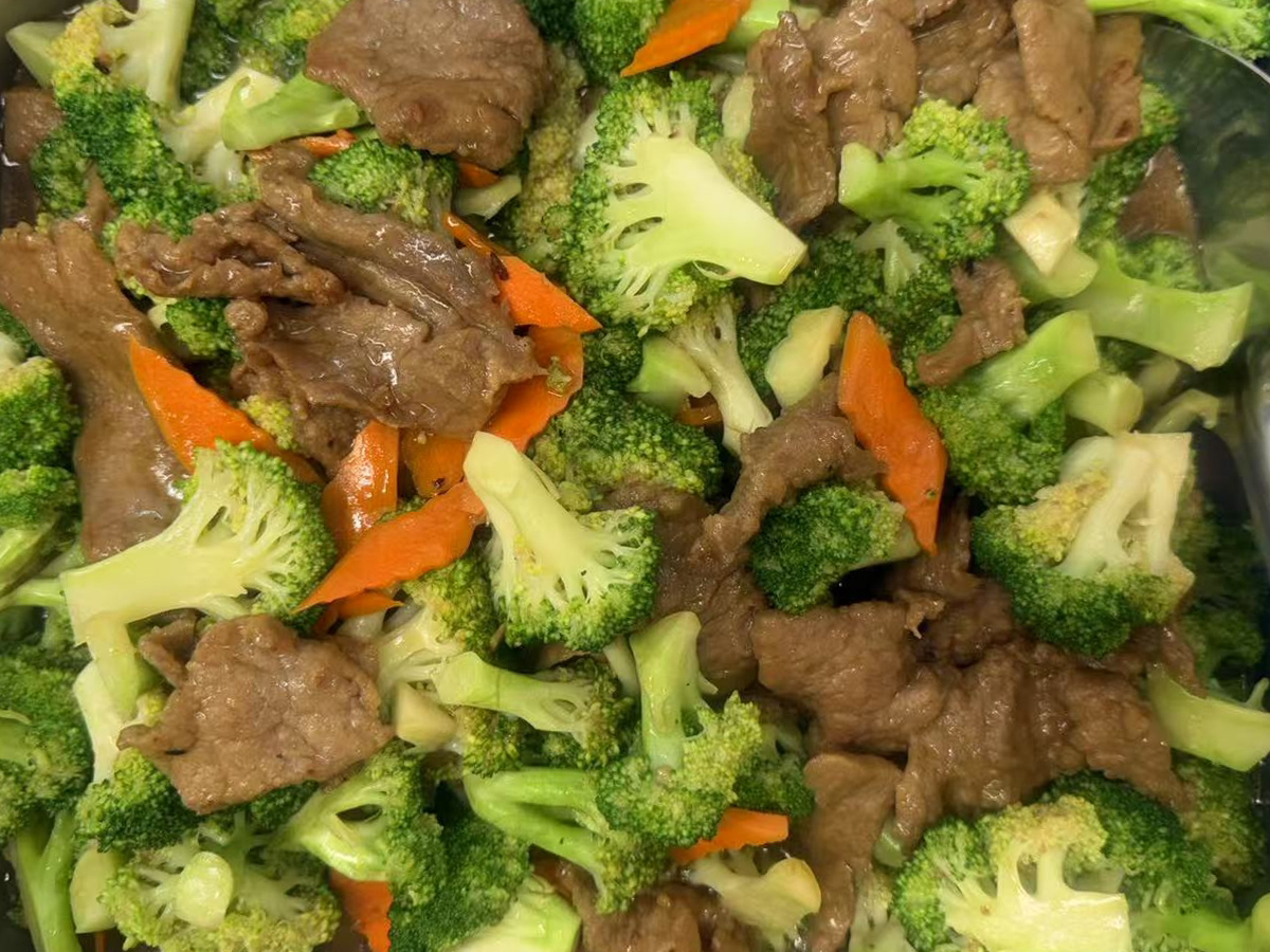 Stir - fried Beef with Broccoli, showing slices of beef and broccoli florets with carrot slices at Golden Dragon，a Asian Fusion Restaurant in Newman