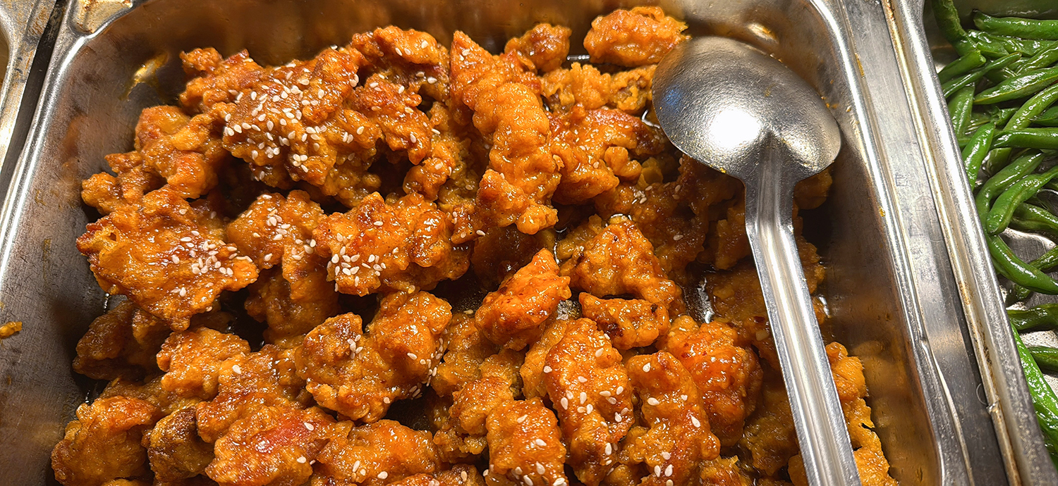 Sesame - topped fried chicken in a serving pan at Golden Wok，a Chinese Restaurant in Weaverville
