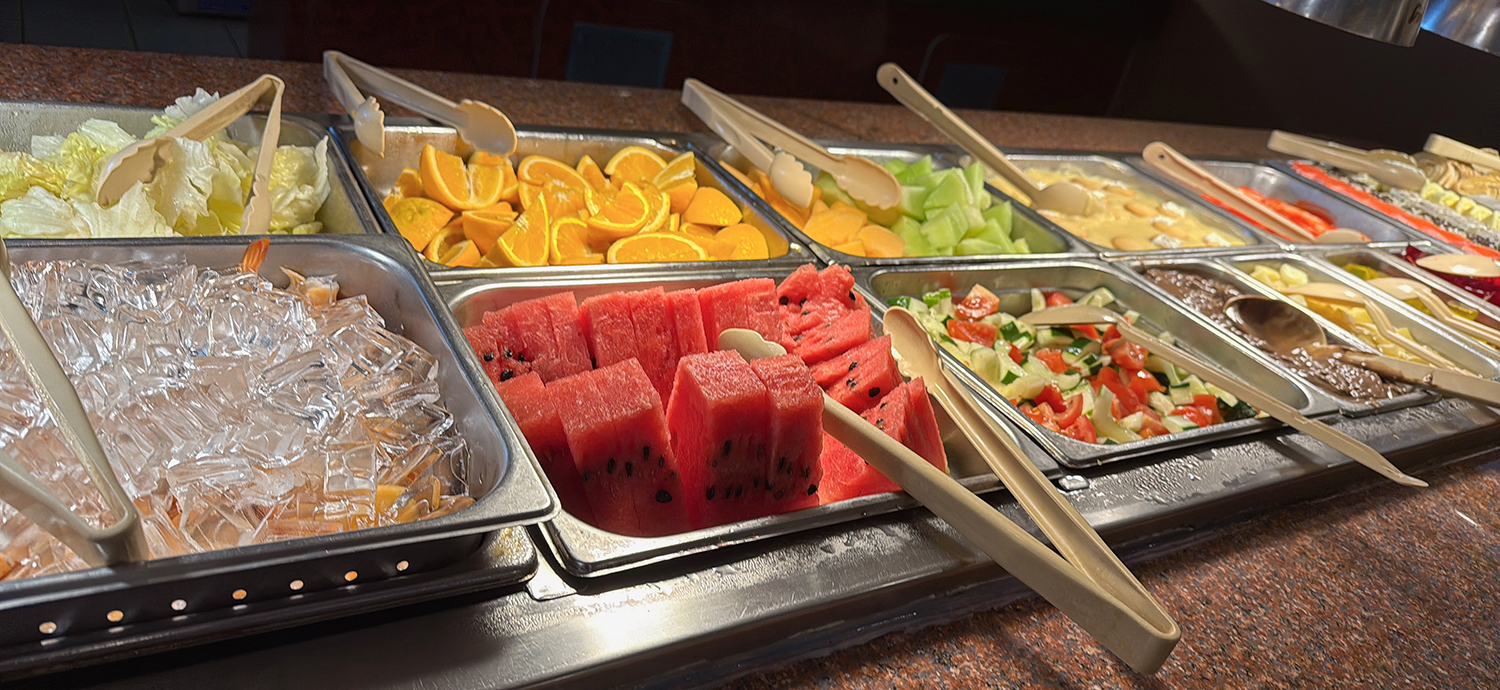 Tray of various fruits like watermelon and orange slices, along with salads at Golden Wok，a Chinese Restaurant in Weaverville
