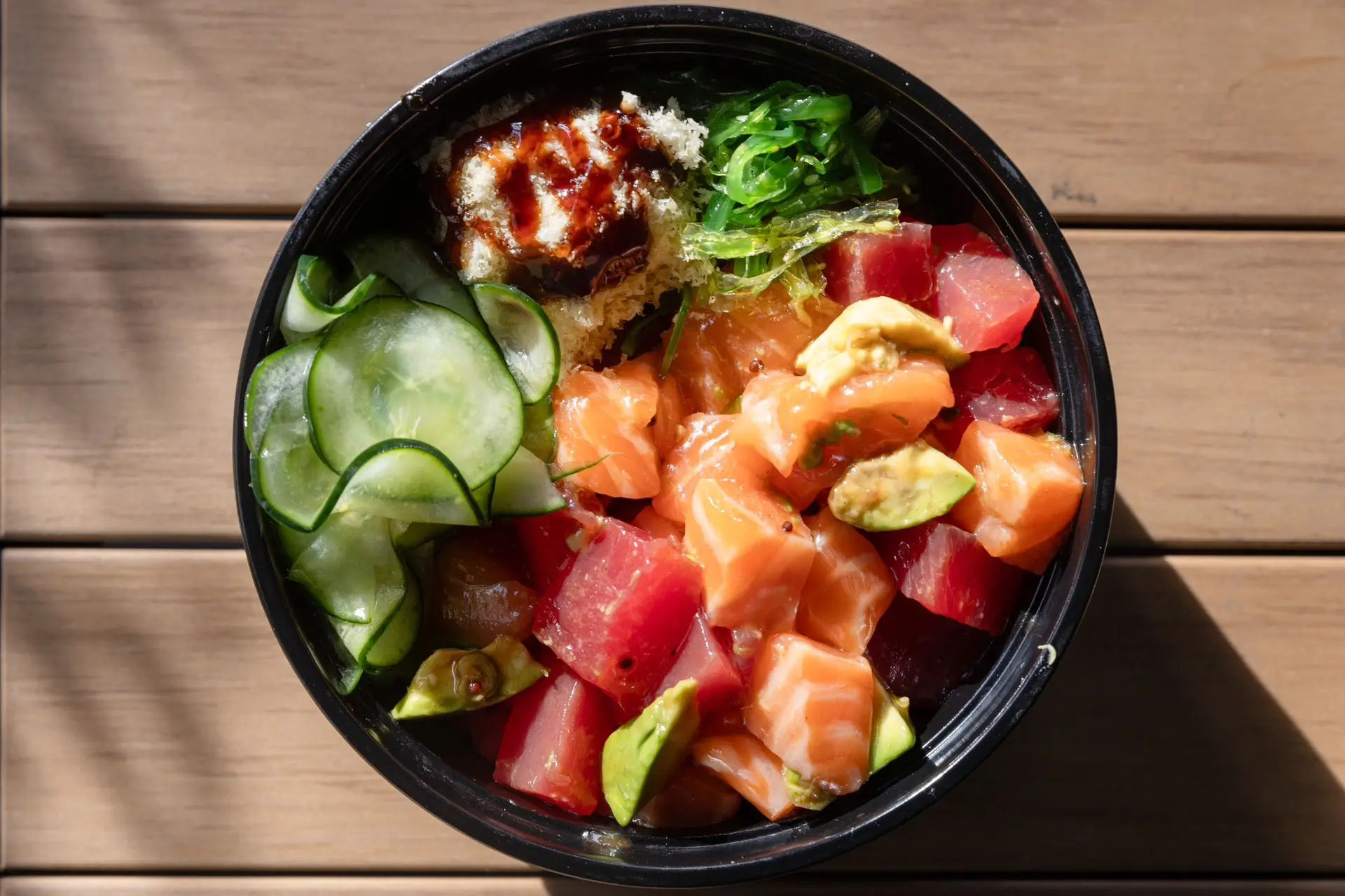 Bowl with diced salmon, tuna, cucumber at Niku Sushi, a Japanese restaurant in Anaheim