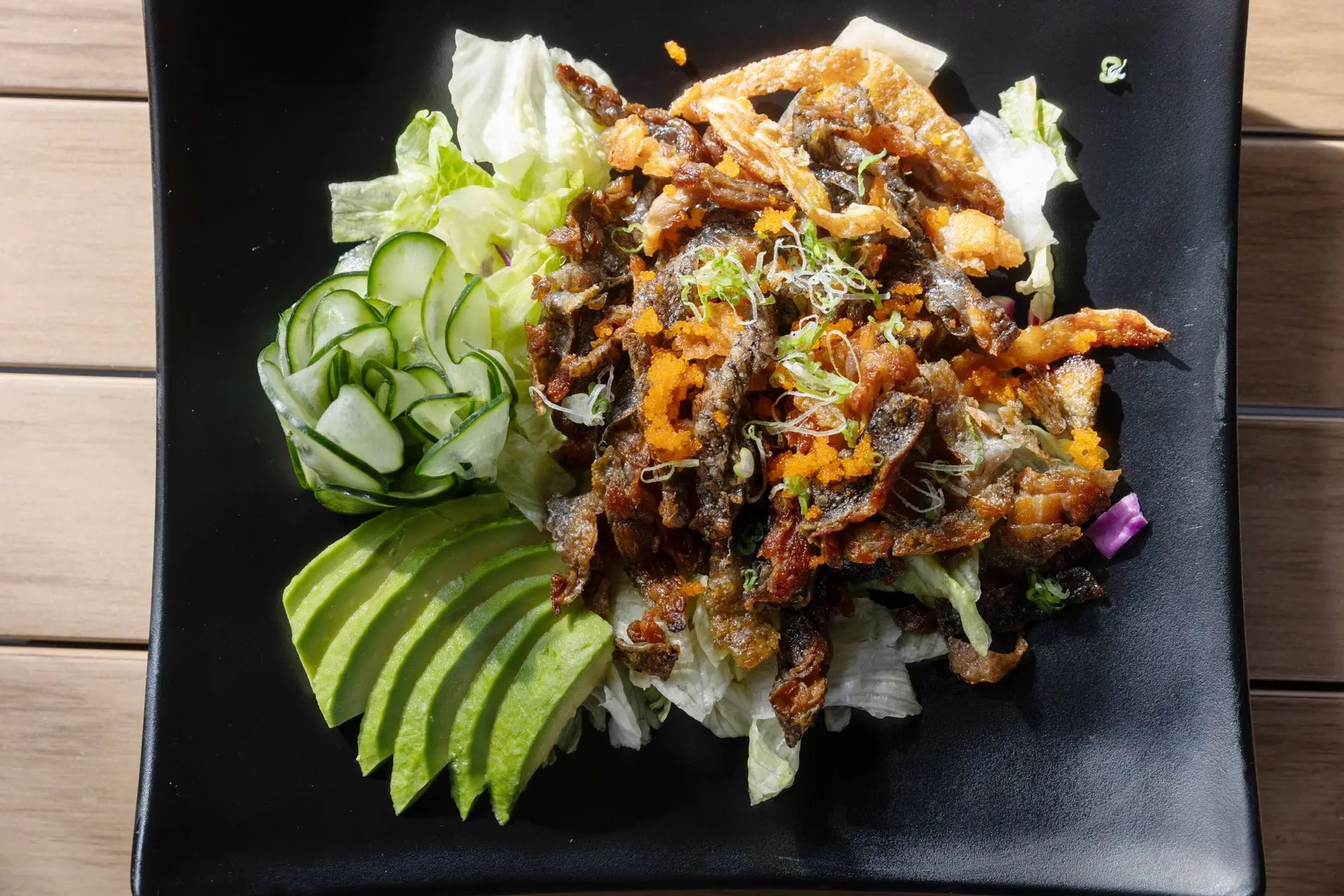 Salad with crispy fish skin, avocado, cucumber and lettuce at Niku Sushi, a Japanese restaurant in Anaheim