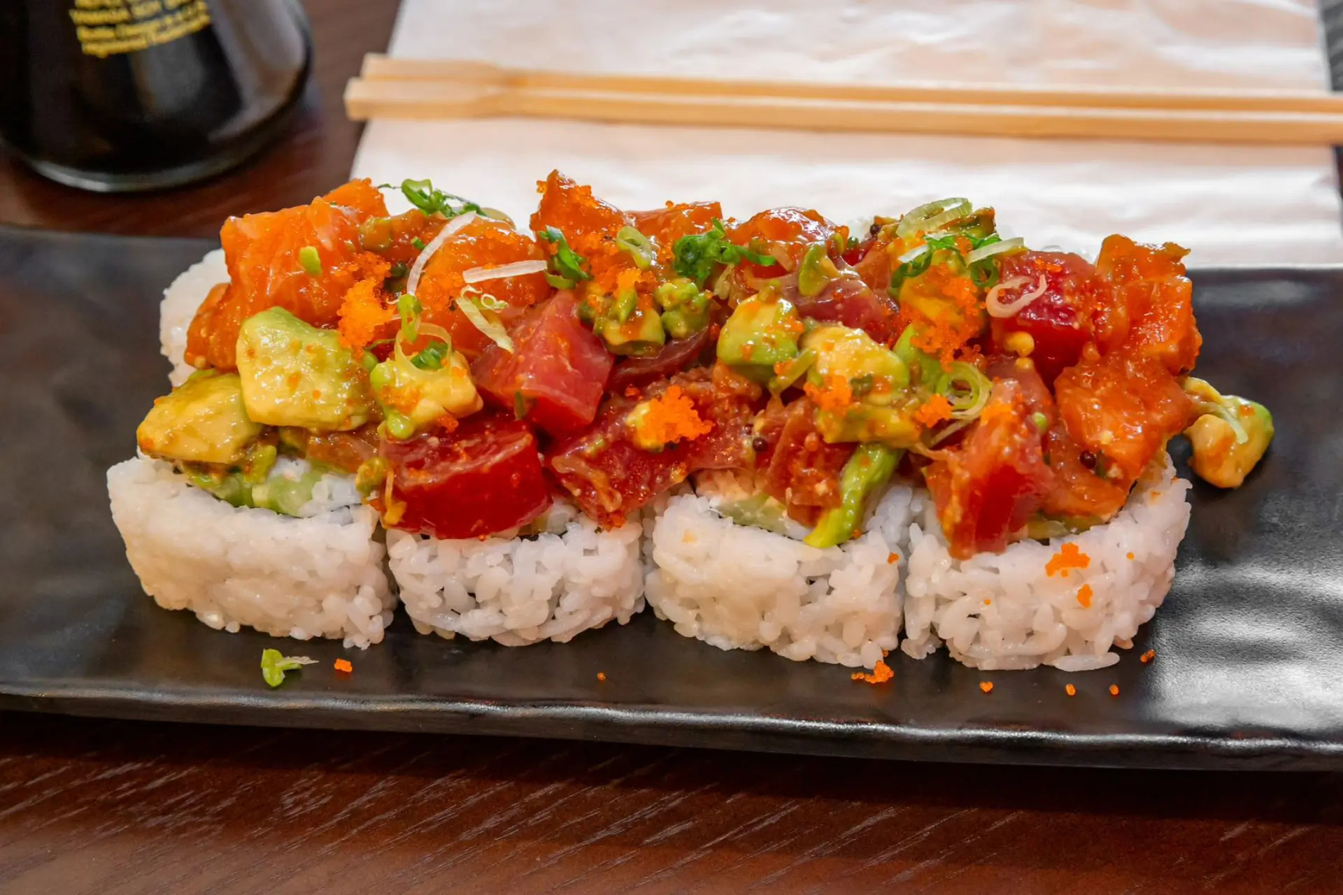 Sushi roll topped with tuna, avocado and fish roe at Niku Sushi, a Japanese restaurant in Anaheim