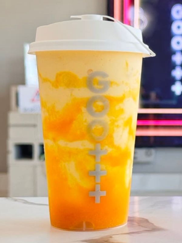 Layered mango fruit slush in Goomo plastic cup at Goomo Tea, a Bubble Tea Store in CA