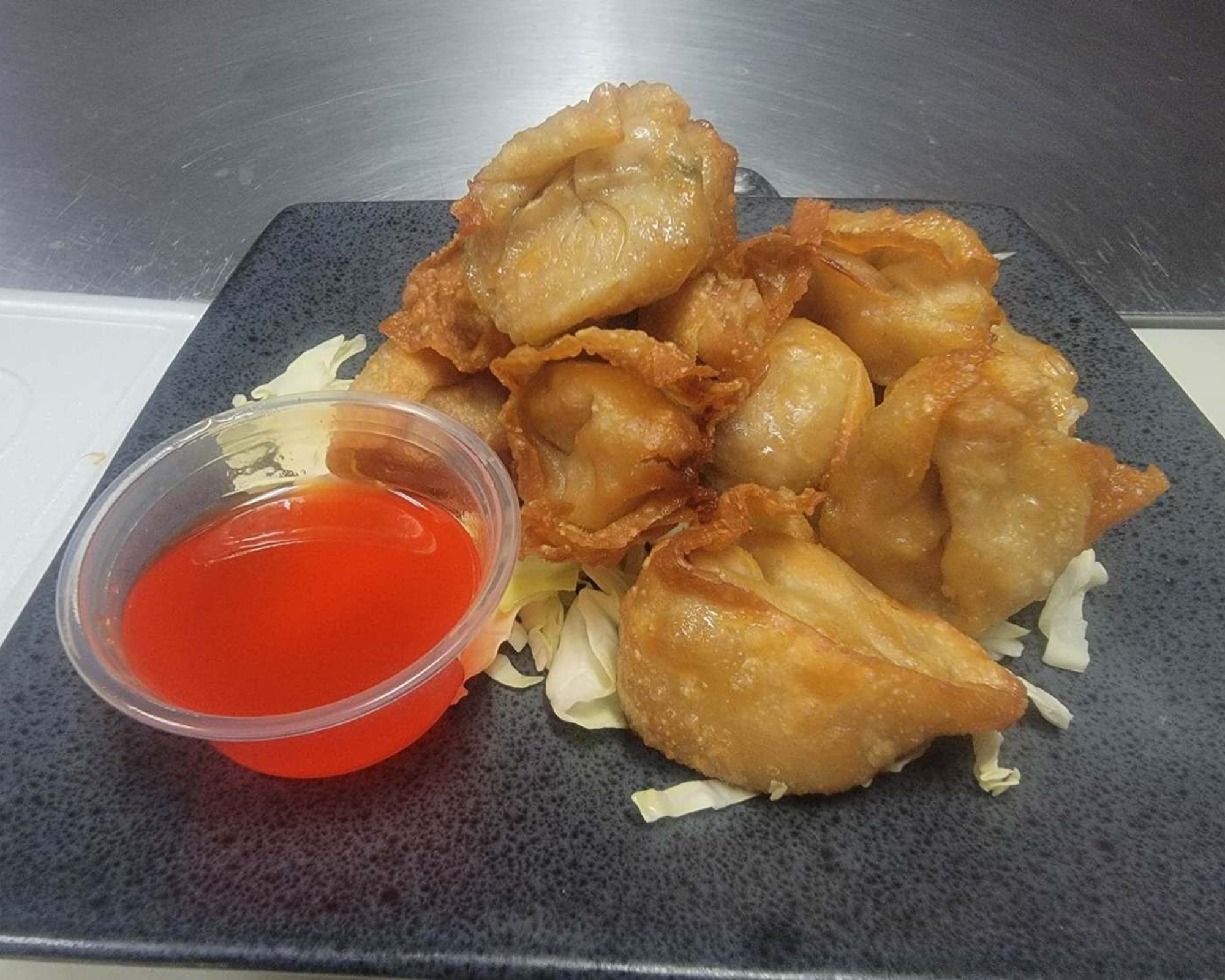 Gourmet-Wok-Chinese-Food-Chinese-Restaurant-Crab-Rangoon-Las-Vegas Crab Rangoon with sweet sauce at Gourmet Wok Chinese Food, a Chinese restaurant in Las Vegas.
