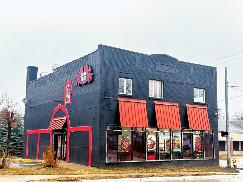 Black building with red accents of Grab Crab at Grab Crab, a Seafood Restaurant in Pontiac