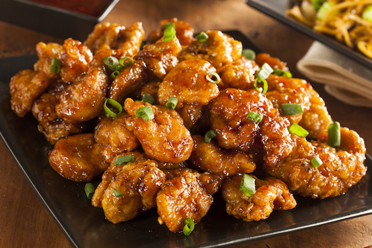 Glazed spicy orange chicken garnished with green onions at Grandma's Dim Sum, a Chinese Restaurant in Flushing