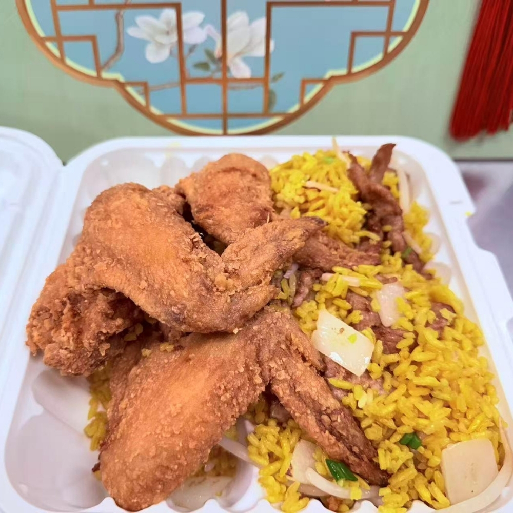 Crispy fried chicken wings with yellow fried rice in a takeout box at Great China, an Chinese Restaurant in Naugatuck