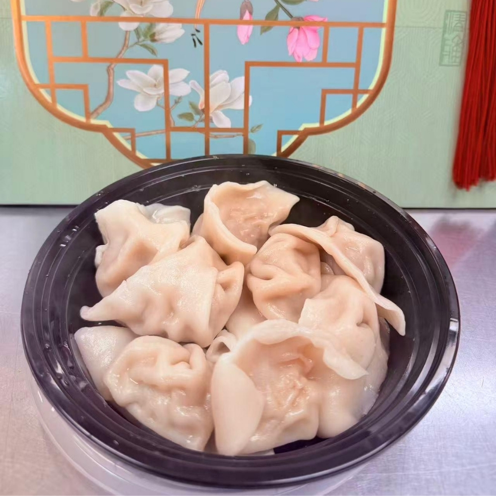 Plump steamed pork dumplings served in a black bowl at Great China, an Chinese Restaurant in Naugatuck
