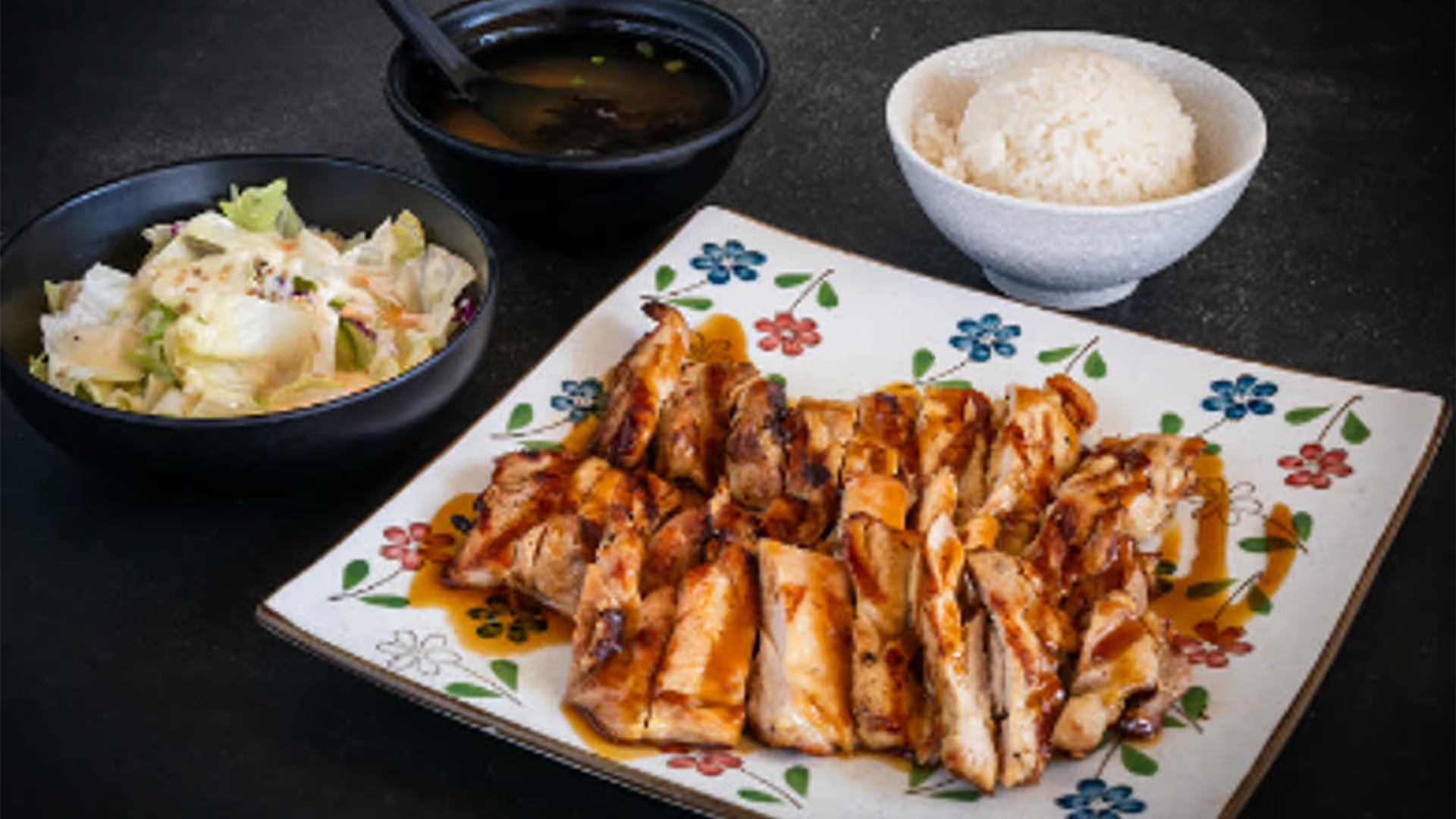 Grilled teriyaki chicken with rice, salad, and miso soup