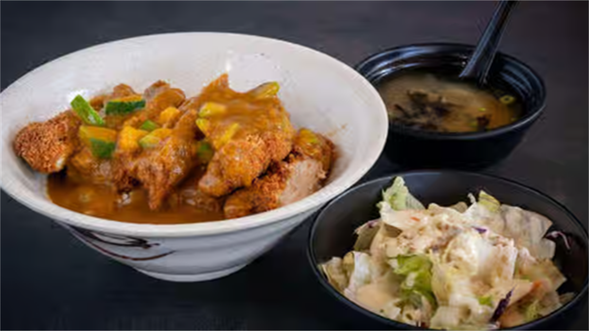 Battered and fried chicken in curry sauce, served with salad and miso soup at Haha Ramen Sushi, a Japanese restaurant in Hayward