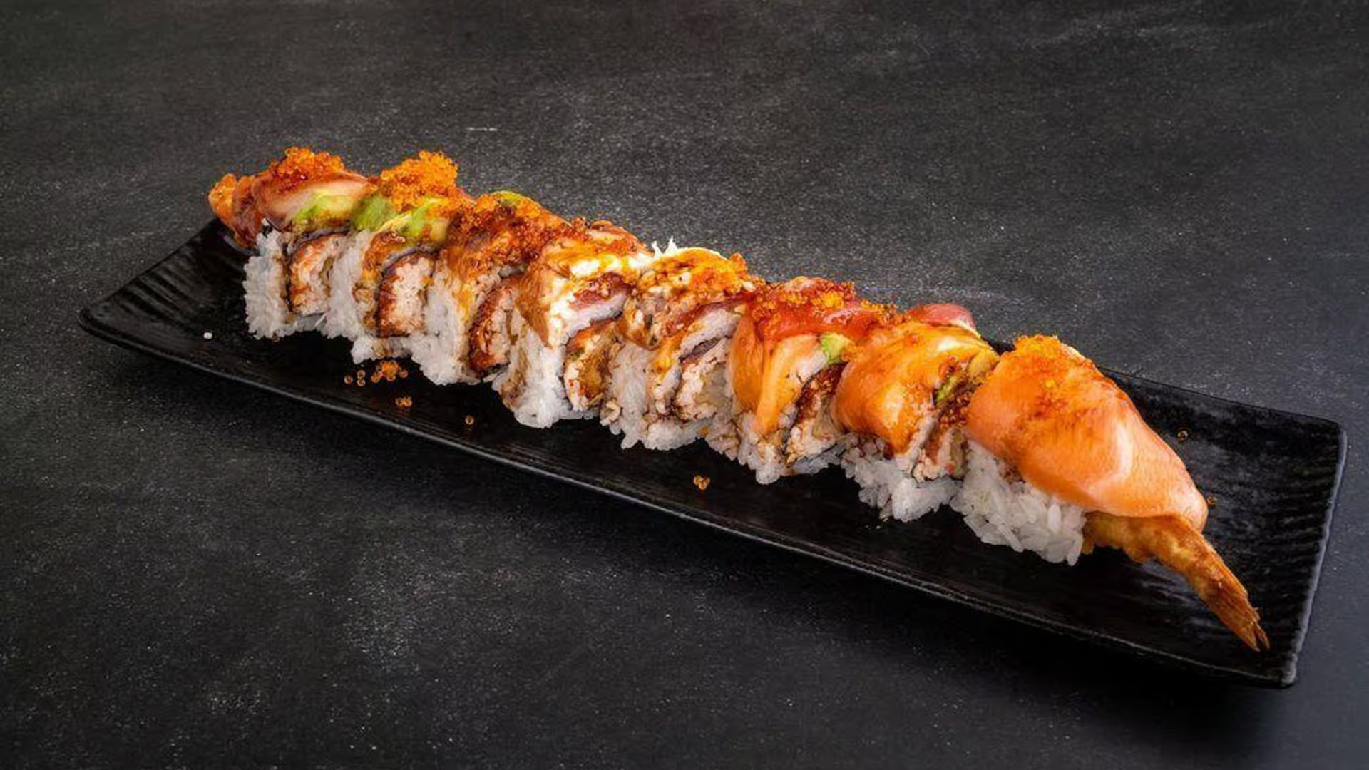 Sushi roll with seafood, veggies, and crispy toppings