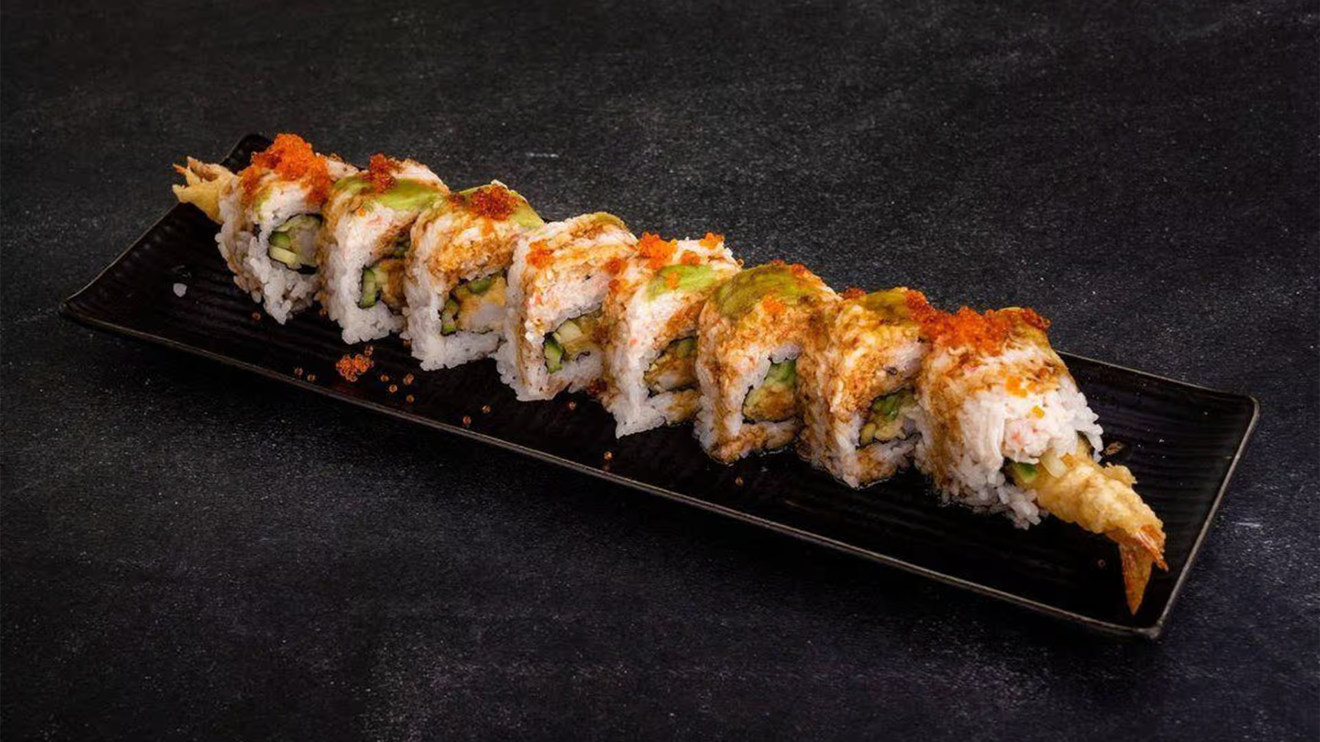 Sushi roll with tempura, veggies, and tobiko at Haha Ramen Sushi, a Japanese restaurant in Hayward
