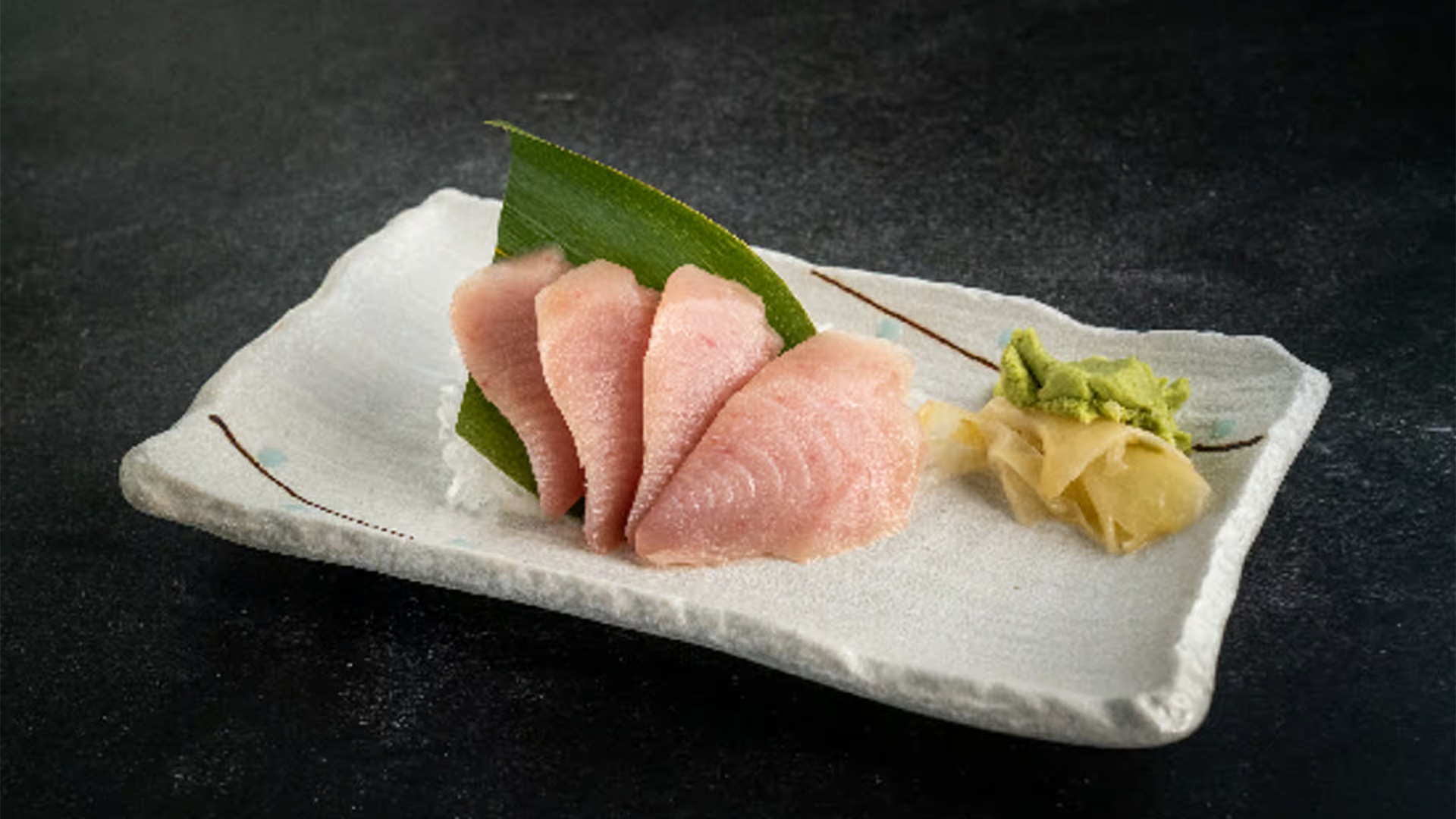 Fresh white tuna sashimi with wasabi and pickled ginger at Haha Ramen Sushi, a Japanese restaurant in Hayward