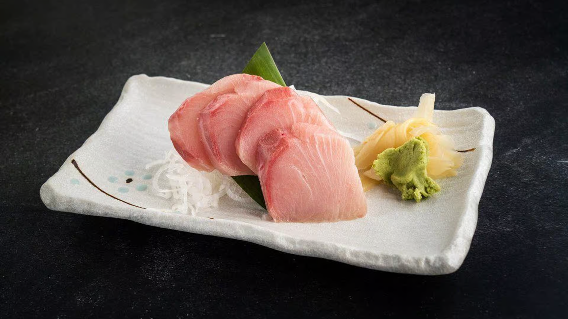 Fresh yellowtail sashimi with wasabi and pickled ginger at Haha Ramen Sushi, a Japanese restaurant in Hayward