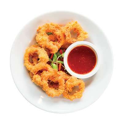 Crispy fried calamari rings with breaded coating and red dipping sauce at Cherry Amber, a Asian fusion restaurant in Plainview