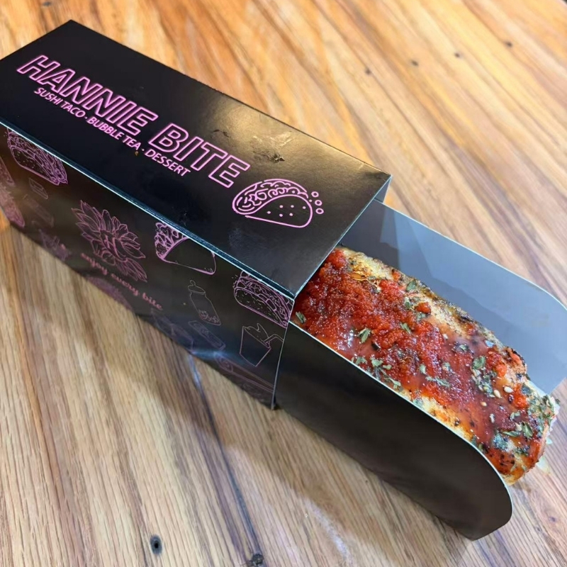 Saucy spicy sushi taco inside brand paper box at Hannie Bite, Asian Restaurant in Philadelphia