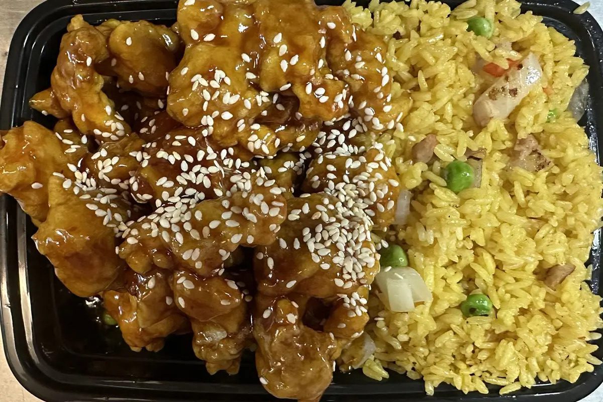 Crispy chicken in sesame sauce served with yellow fried rice at Happy China, a Chinese Restaurant in Martinez