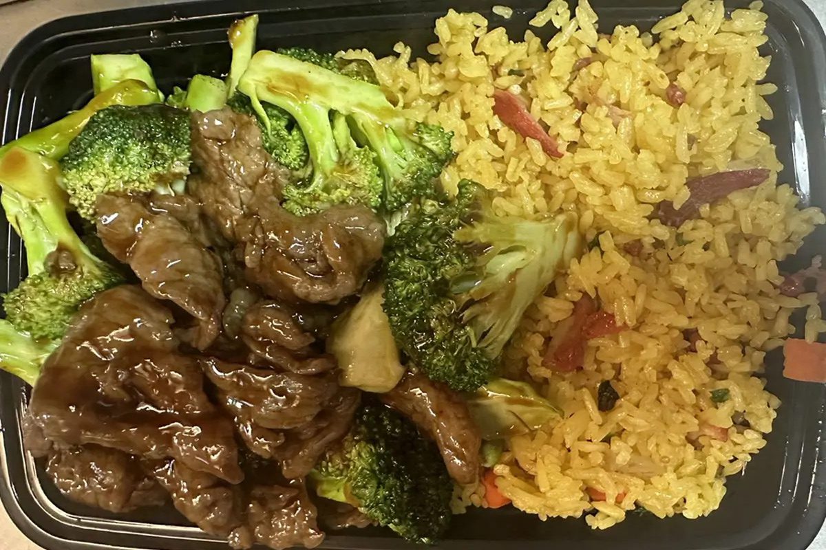 Sliced beef and broccoli stir-fried, served with yellow fried rice at Happy China, a Chinese Restaurant in Martinez