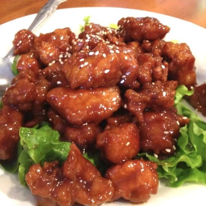 Glossy boneless pork with sesame seeds, served on lettuce at Happy Kitchen, a Chinese restaurant in Chino Hills