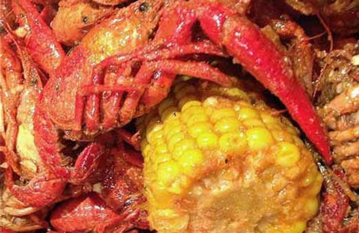 Seasoned crawfish boil with buttery corn at Harbor Seafood Cajun House, a Seafood Restaurant in Phoenix