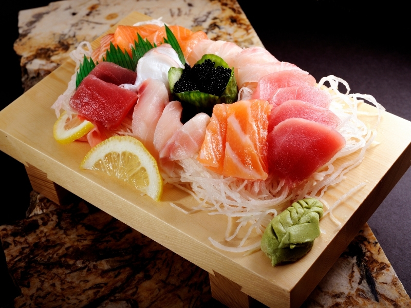 Assorted fresh sashimi platter on a wooden board at Haru, a Japanese Restaurant in MIDDLETON