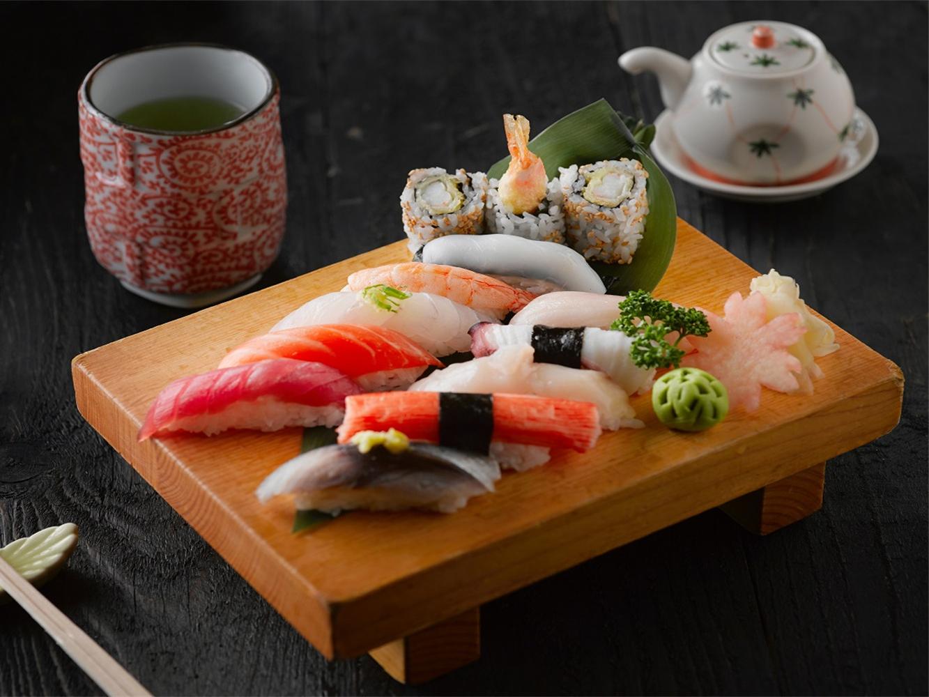 A platter of assorted sushi including nigiri and maki, served with green tea at Billings Heights Hokkaido Ramen House, a Japanese restaurant in Billings