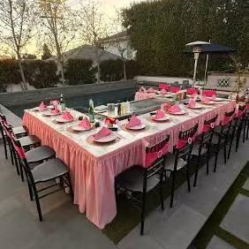 Backyard setup with tables, chairs, hibachi grill for outdoor party.