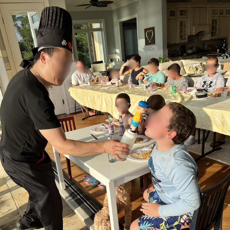 Hibachi-At-Yours-Hibachi-Restaurant-Chef-Entertaining-Kids-Columbia Chef entertains kids during meal at Hibachi At Yours,a Hibachi Restaurant in Columbia.
