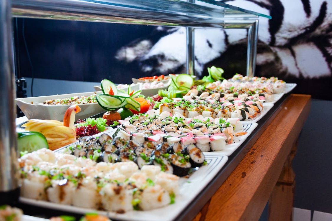 Sushi platter with assorted rolls and garnishes.