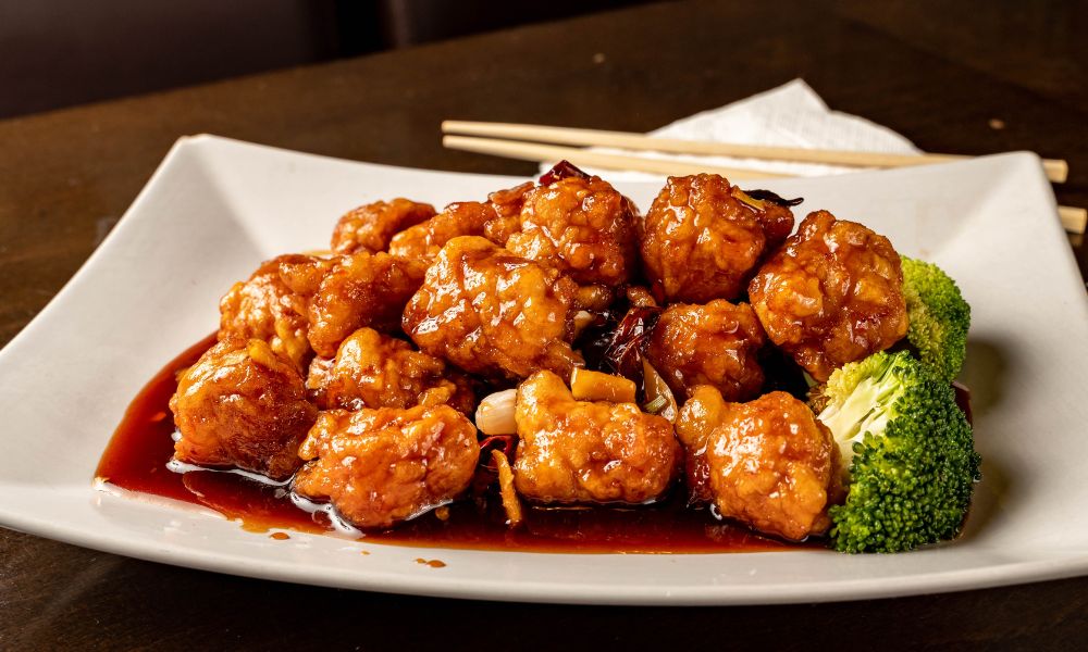 Crispy orange chicken with broccoli in a sweet, glossy sauce at High Five Asian Street Food, a Asian restaurant in Ormond Beach