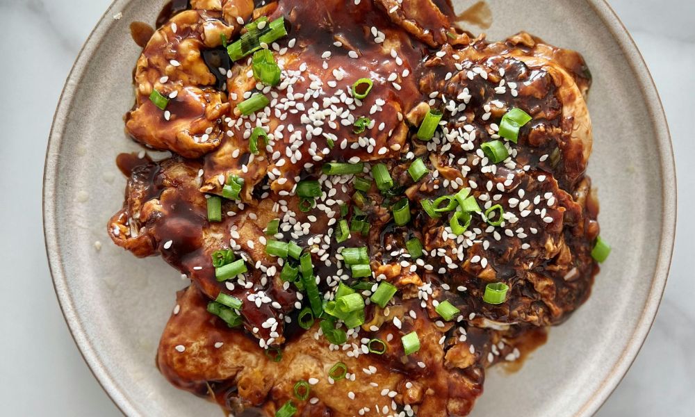 Grilled chicken thighs glazed with teriyaki sauce, sesame seeds and scallions at High Five Asian Street Food, a Asian restaurant in Ormond Beach