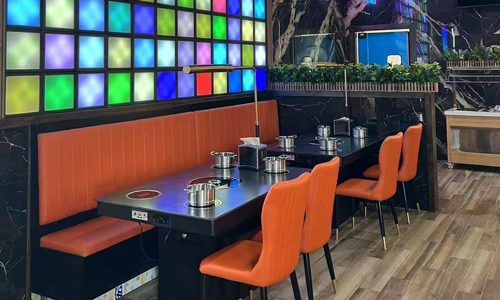 Colorful-lit hot pot booth with modern seating at Hi Pot, a Hot Pot & Bbq Restaurant in Spring