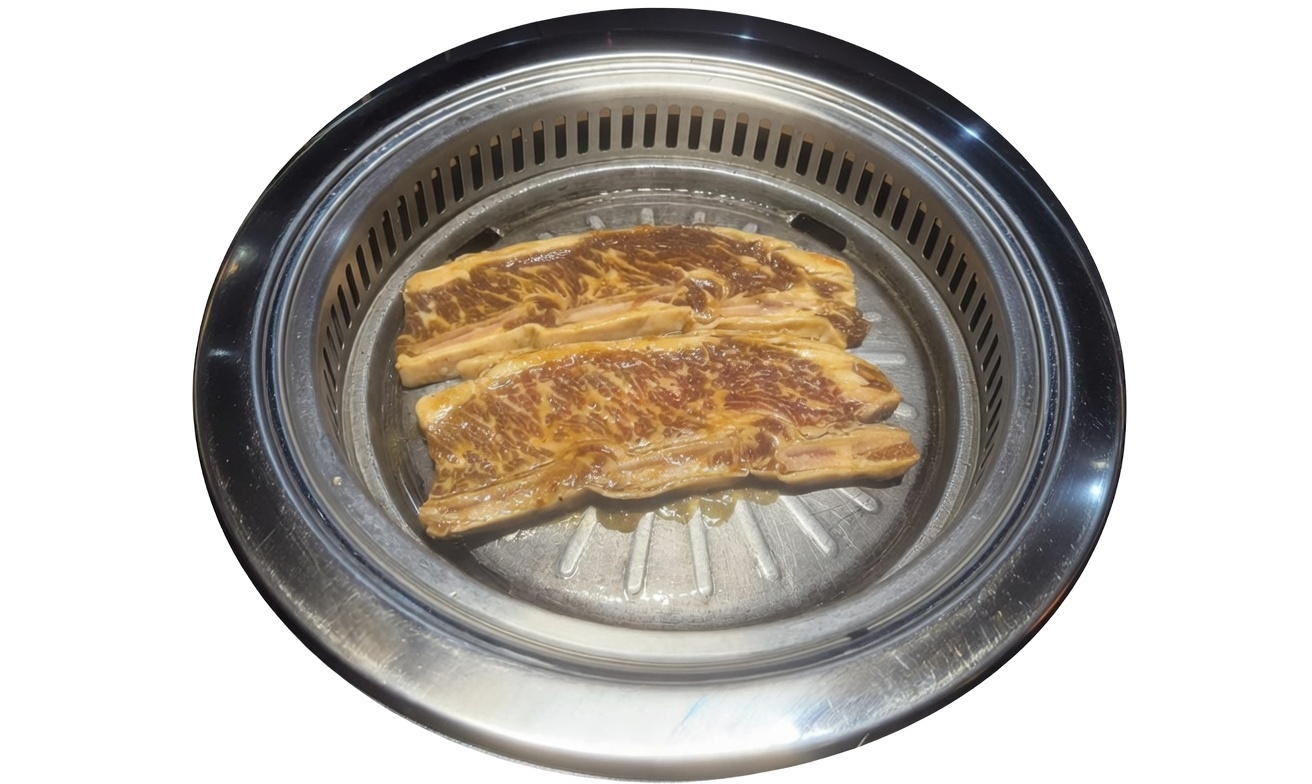 Hot pot with spicy and mild broth, featuring seafood, mushrooms, and vegetables, being enjoyed with chopsticks.