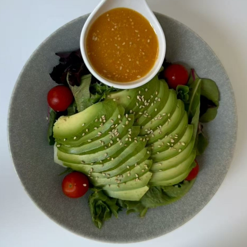Hiromi-Sushi-Sushi-restaurant-Avocado-Salad-New-York Avocado slices on greens with sesame dressing. At Hiromi Sushi,a Sushi Restaurant in New York