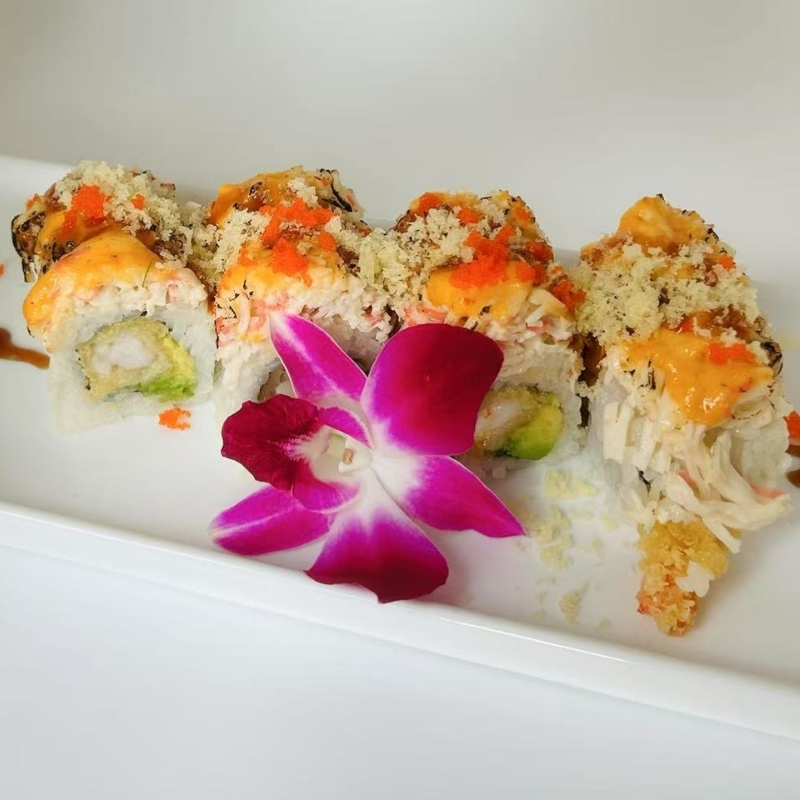 Hiromi-Sushi-Sushi-restaurant-Crispy-Sushi-Rolls-New-York Sushi rolls with crunchy toppings and an orchid. At Hiromi Sushi,a Sushi Restaurant in New York
