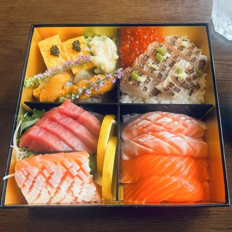 Hiromi-Sushi-Sushi-restaurant-Deluxe-Bento-Box-New-York Assorted sashimi and sushi in a box. At Hiromi Sushi,a Sushi Restaurant in New York