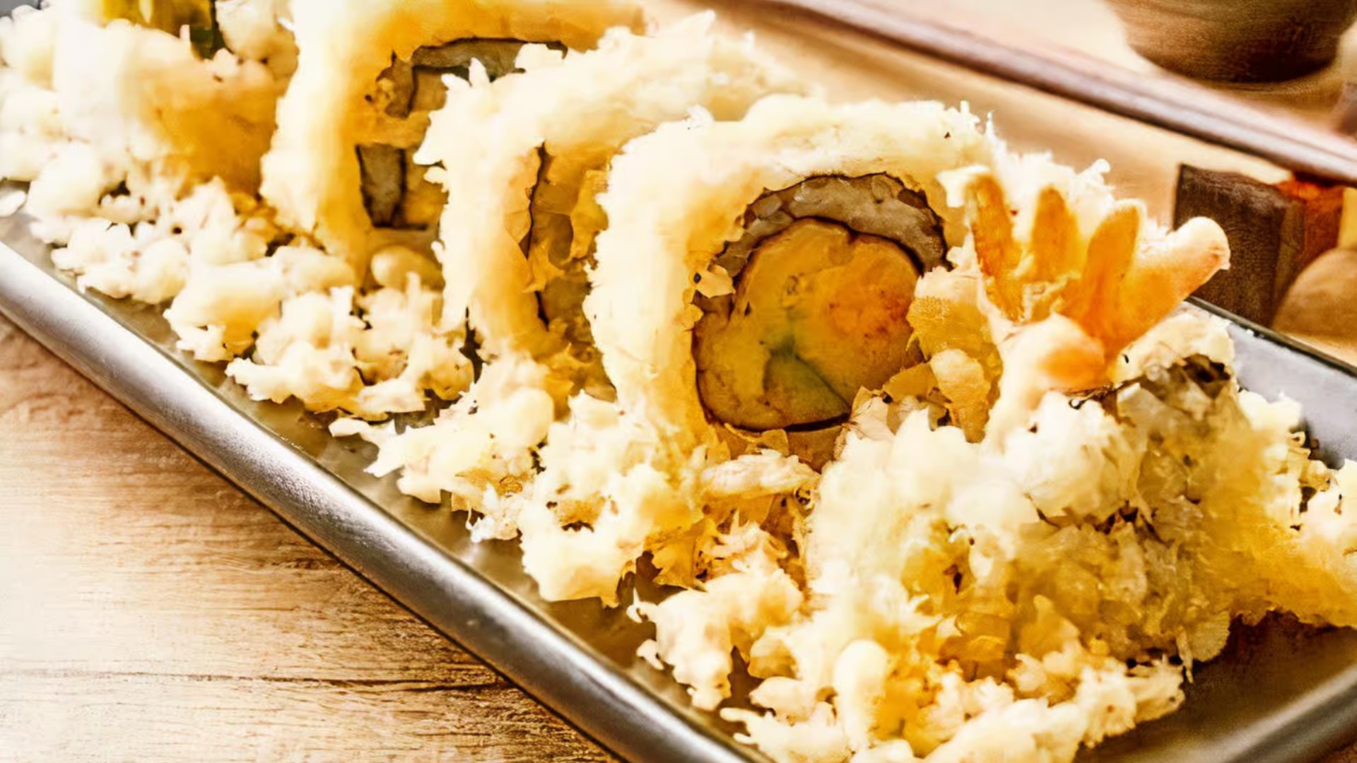 Crunchy tempura sushi rolls on a metal tray