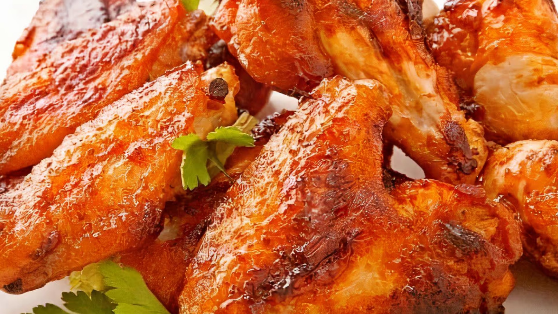 Glazed roasted chicken wings with cilantro garnish