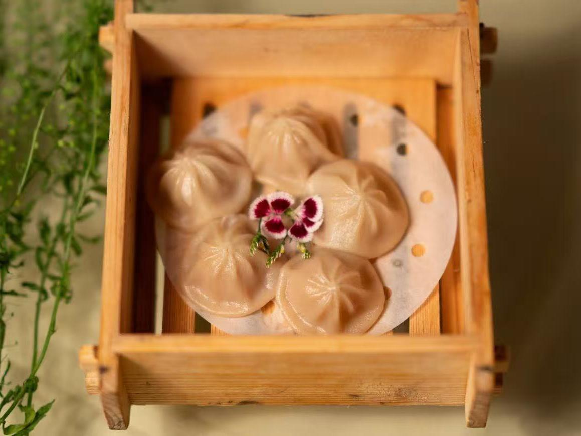 Baby dragon bao soup dumpling in wooden steamer box at HK Bistro, a Chines Hong Kong Restaurant in Portland